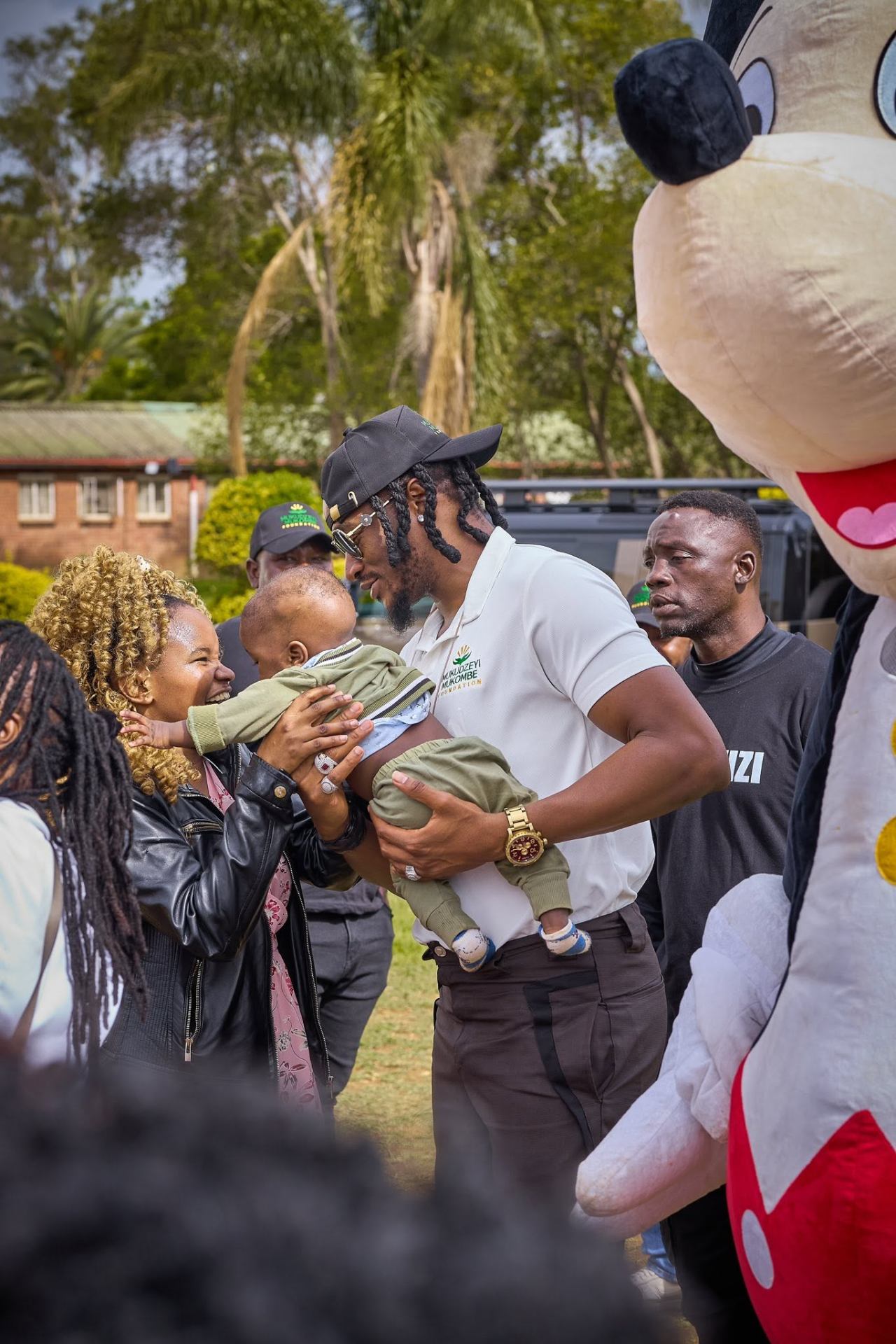Foundation founder Jah Prayzah greeting a mother and her baby
